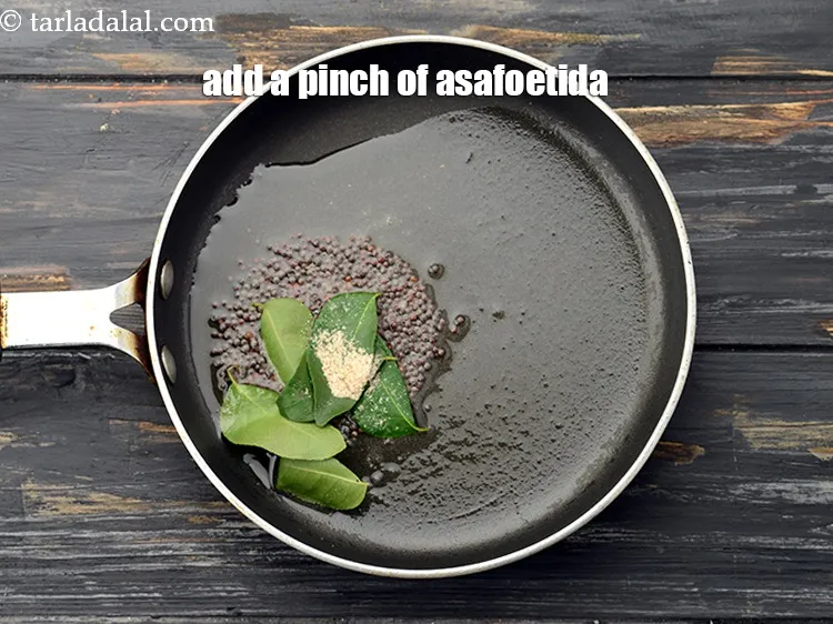 Step 23 – Add a pinch of <a href="https://www.tarladalal.com/glossary-asafoetida-hing-113i">asafoetida (hing)</a>.&nbsp;