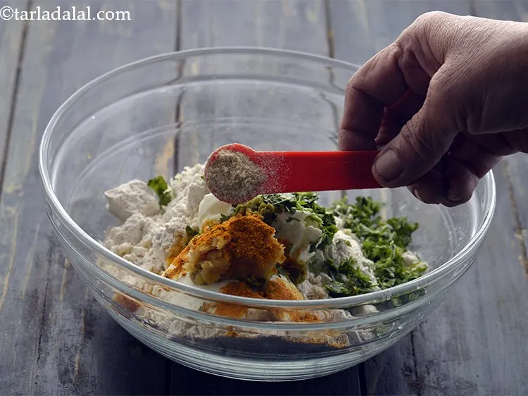 Step 11 – Add &frac14; tsp of asafoetida. Though muthias are a light snack but, the hing aids …