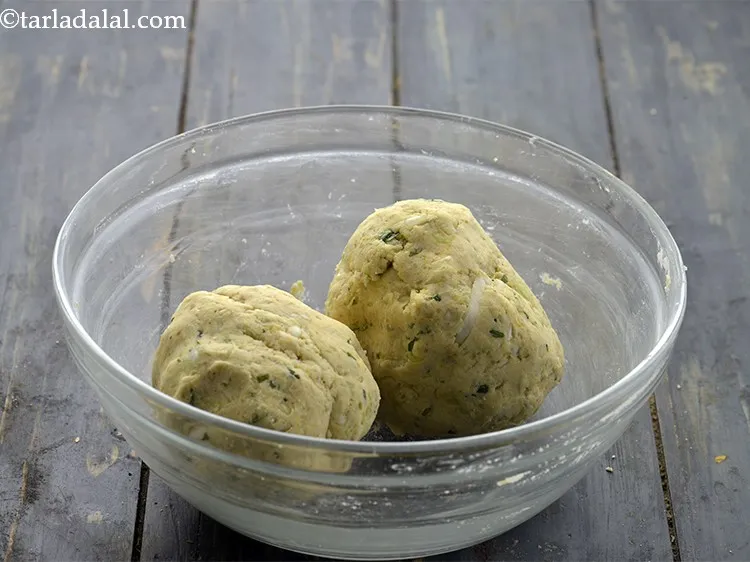 Step 15 – Divide the Gujarati <strong>cabbage muthiya</strong> dough into 2 equal portions. Remember to make the dumplings …