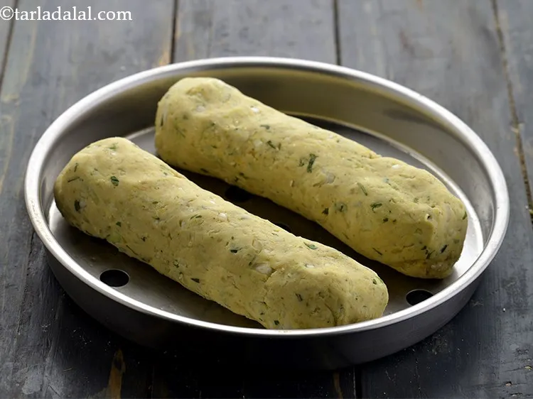 Step 18 – Arrange both the <strong>kobi jowar muthia</strong> rolls on a greased sieve. Keep proper distance between …