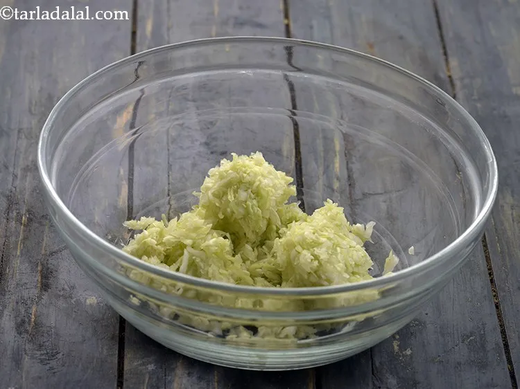 Step 3 – In a deep bowl put the grated cabbage. Bottle gourd, spinach, carrots, fenugreek leaves can …