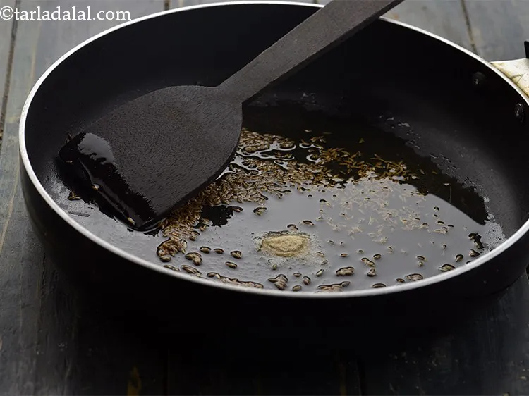 Step 22 – When the seeds crackle, add the remaining &frac14; tsp of asafoetida.