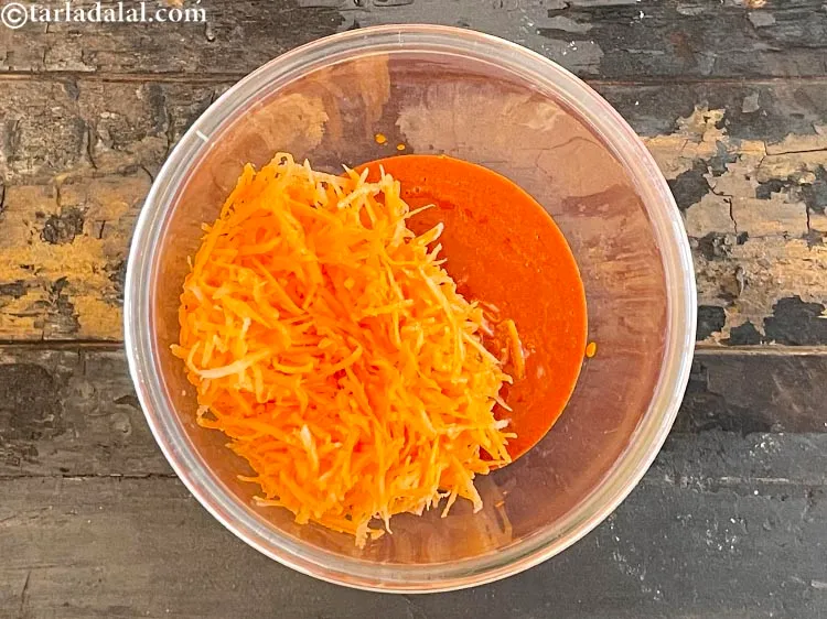 स्टेप 18 – १ कप मोटा <a href=""https://www.tarladalal.com/glossary-grated-carrot-hindi-816i"">कद्दूकस किया हुआ गाजर</a> डालें।