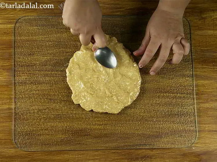 Step 6 – Spread the&nbsp;<strong>Praline (Cashew Praline)&nbsp;</strong>mixture immediately on the greased surface with the help of a spatula …