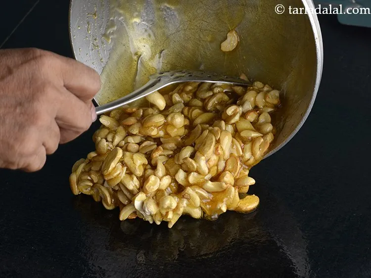 Step 11 – Immediately pour the mixture of <strong>Cashew nut Brittle</strong> on a greased platform.&nbsp;