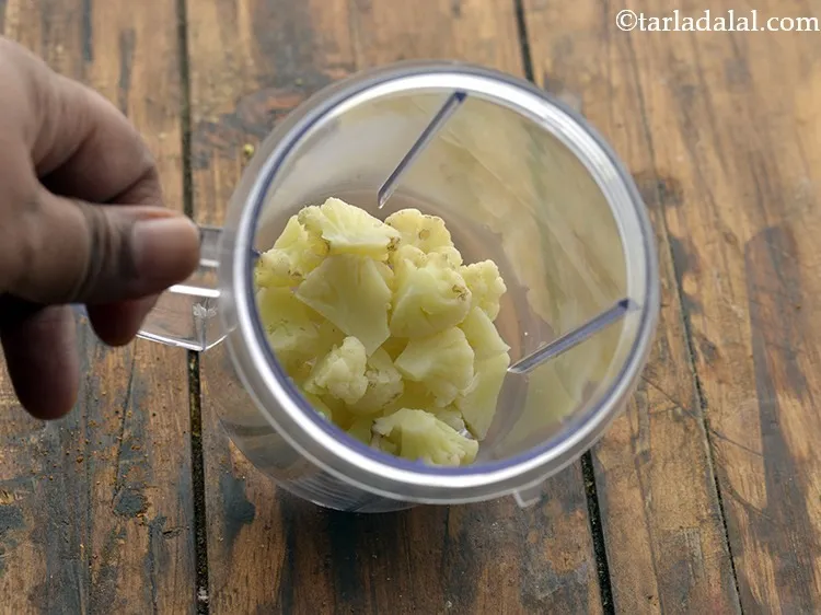 Step 18 – Now take a clean sterilized mixer jar. Add the blanched cauliflower to it.