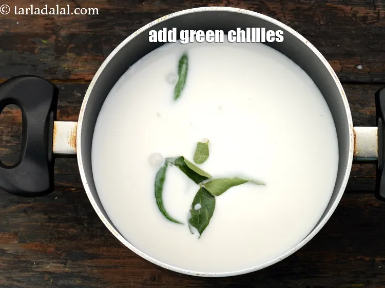 Step 20 – Add&nbsp;2&nbsp;<a href="https://www.tarladalal.com/glossary-slit-green-chillies-1856i">green chillies , slit</a>.&nbsp;