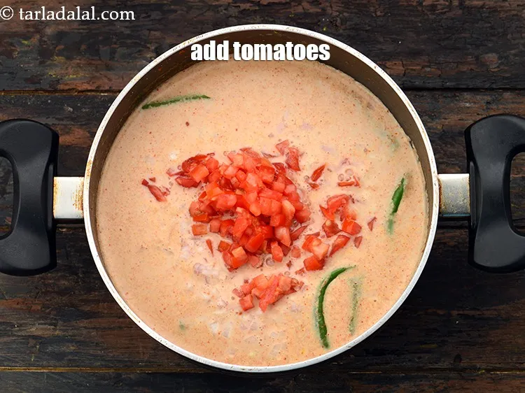 Step 26 – Add 1 cup&nbsp;finely&nbsp;<a href="https://www.tarladalal.com/glossary-chopped-tomatoes-779i">chopped tomatoes</a>.&nbsp;This gives that little sourness.&nbsp;