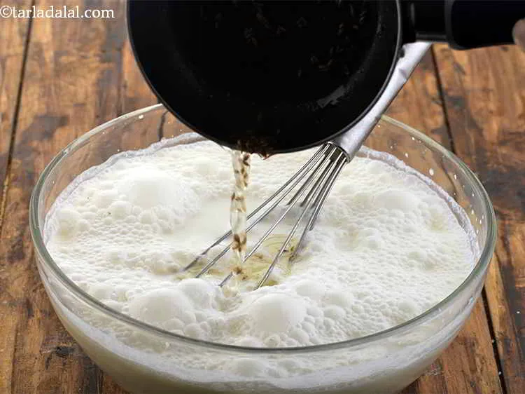 Step 10 – Pour the tempering over the&nbsp;<strong>chaas | plain Indian buttermilk | plain chaas recipe |</strong>