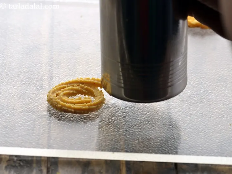 Step 19 – Press the chaklis very gently with the back of a flat ladle. If you are …