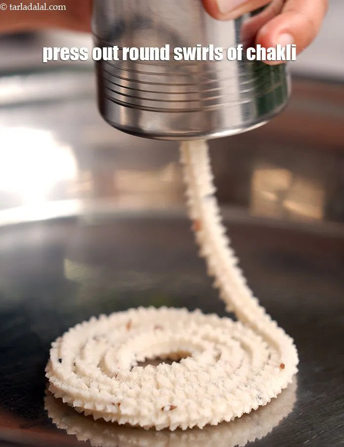 Step 14 – Press out 75 mm. (3&rdquo;) diameter round swirls of chakli.