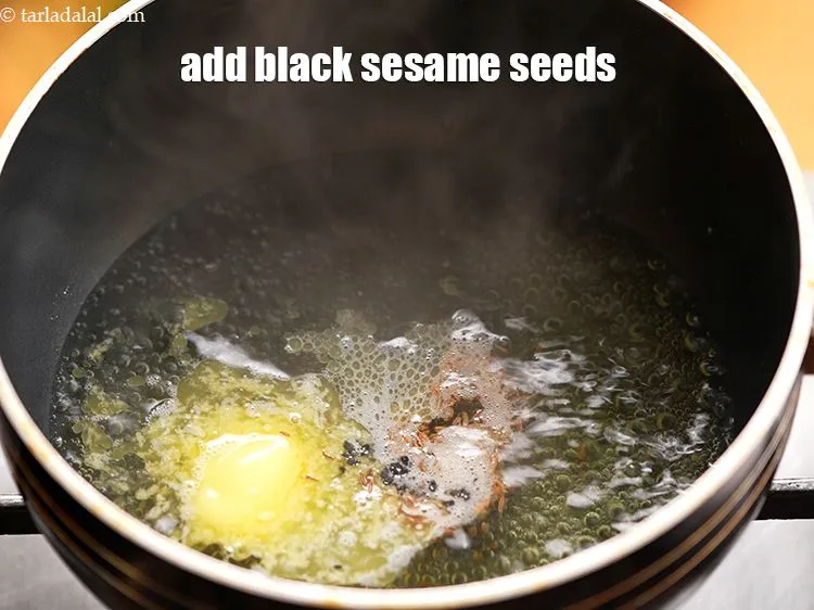 Step 6 – Add &frac12; tsp <a href="https://www.tarladalal.com/glossary-black-sesame-seeds-kala-til-kale-til-862i">black sesame seeds (kala til)</a>.