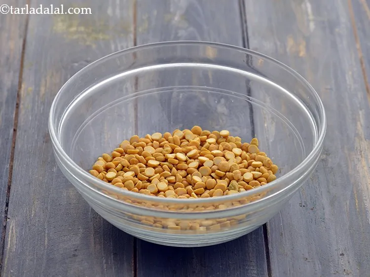 Step 11 – Pick and clean 1/2 cup&nbsp;<a href="https://www.tarladalal.com/glossary-chana-dal-split-bengal-gram-285i">chana dal (split bengal gram)</a>&nbsp;and transfer into a deep bowl.