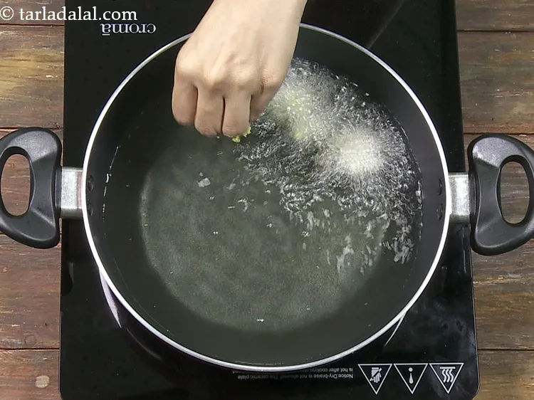 Step 30 – Drop spoonfuls of the batter in the oil.