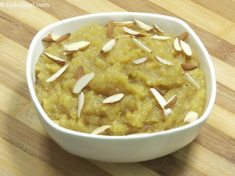 Step 23 – Transfer the chana dal halwa in serving bowls and garnish with almond slivers.