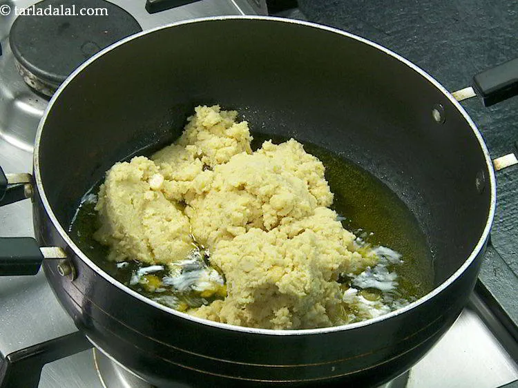 Step 9 – When the ghee is hot and melts, carefully add the chana dal mixture.