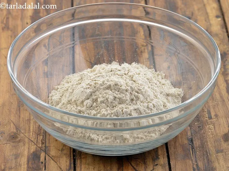 Step 11 – Add 1 cup <a href="https://www.tarladalal.com/glossary-whole-wheat-flour-gehun-ka-atta-gehun-ka-aata-429i">whole wheat flour (gehun ka atta)</a>.