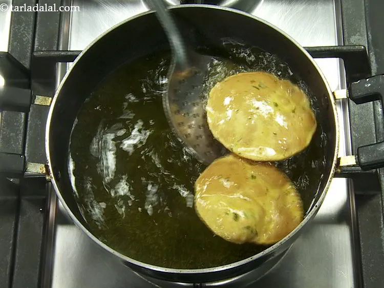 Step 23 – Heat the oil in a deep non-stick pan and deep-fry the puris a few at …