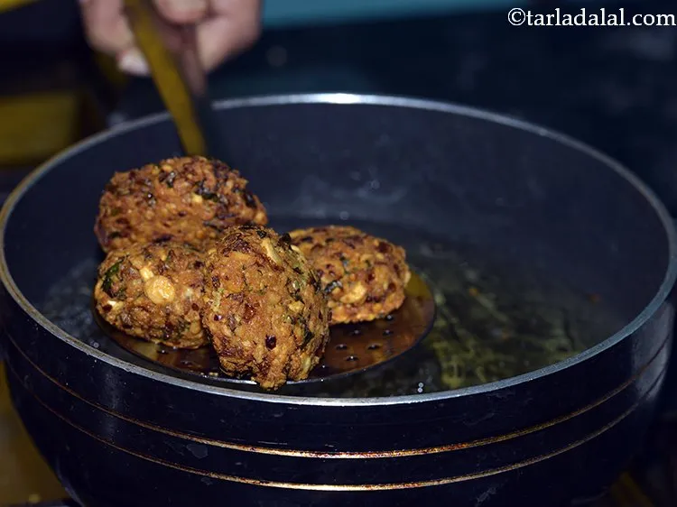 Step 22 – With the help of a slotted spoon flip them and fry till they are golden …