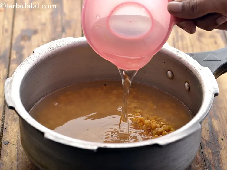 Step 23 – Add 2 cups of water for cooking the dal.&nbsp;