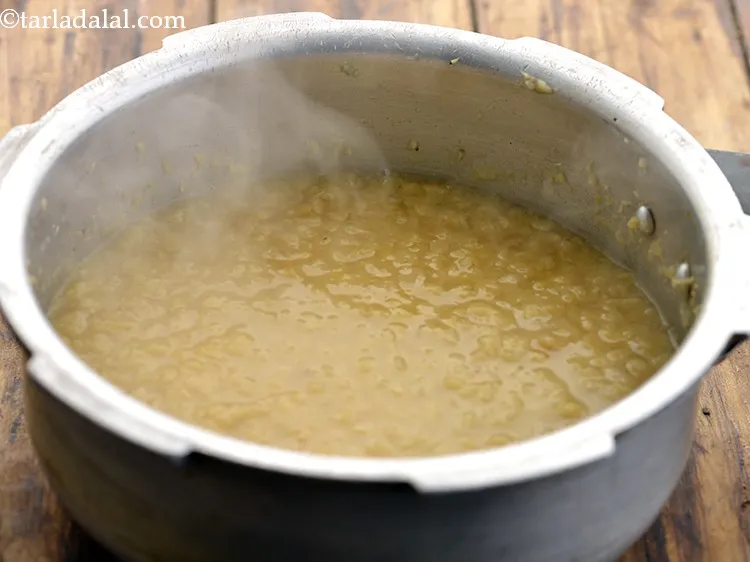 Step 28 – When the seeds crackle, add the cooked dal.