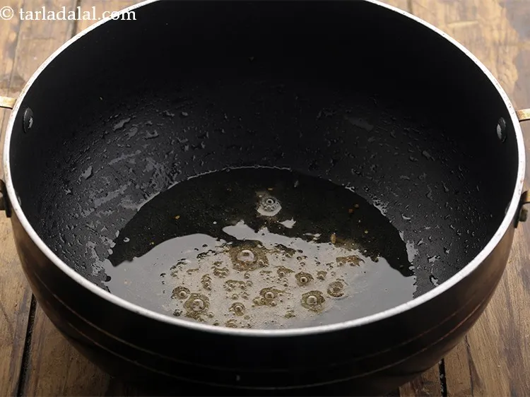 Step 13 – To make <strong>chickpeas with spinach</strong>, heat remaining 3 tbsp oil in a deep non-stick kadhai …