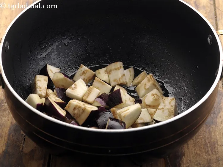 Step 8 – Once the oil is hot, add brinjal pieces. Though you won&rsquo;t be able to make …