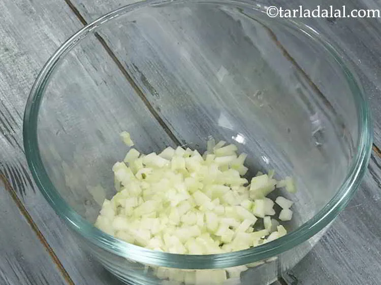 Step 5 – In a deep bowl, take finely chopped cucumber.