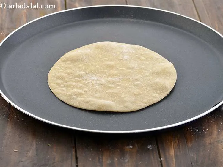 Step 11 – Heat a non-stick tava (griddle) on a high flame and when hot, lower the flame …