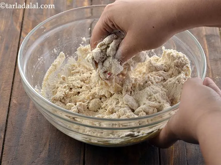 Step 11 – Mix it well with your hands. Gather the flour from all sides. Add more water …