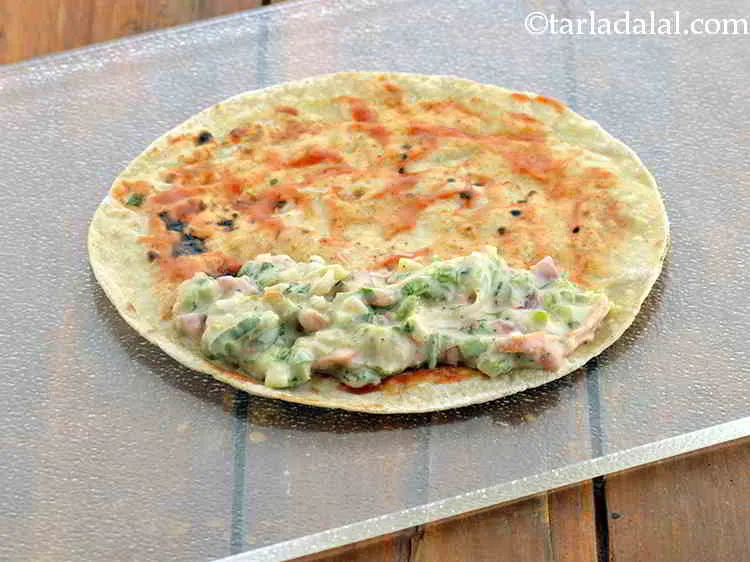 Step 17 – Place a portion of the stuffing on one side of the chapatti.