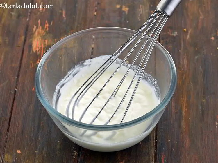 Step 25 – <strong>For the curd dressing</strong>, add 1/2 cup&nbsp;fresh&nbsp;<a href="https://www.tarladalal.com/glossary-curd-dahi-yogurt-yoghurt-383i">curds (dahi)</a> in a bowl.