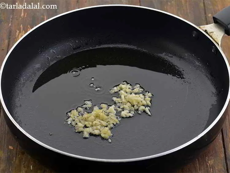 Step 11 – Add 2 tsp&nbsp;finely&nbsp;<a href="https://www.tarladalal.com/glossary-chopped-garlic-790i">chopped garlic (lehsun)</a>.