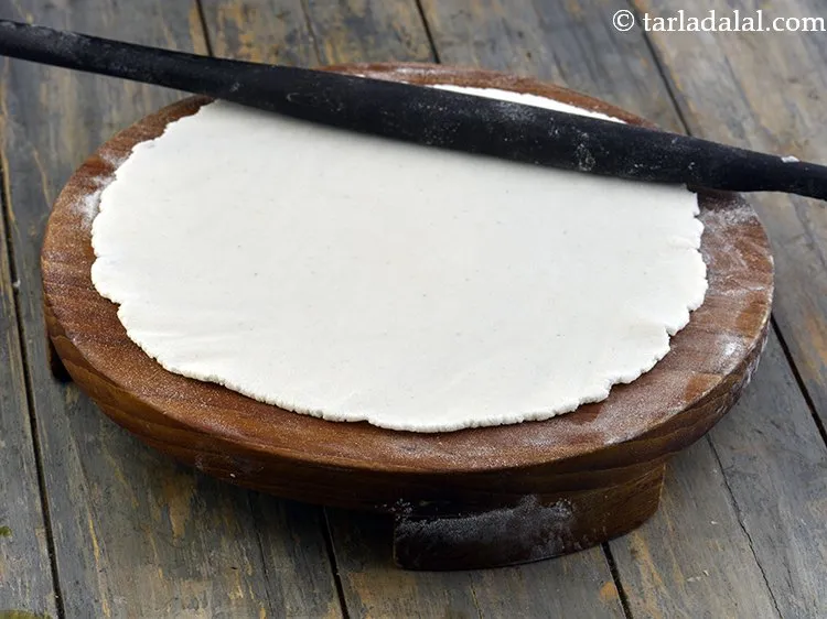 Step 7 – Roll out each portion of the dough into a 200 mm. (8&rdquo;) diameter circle using …