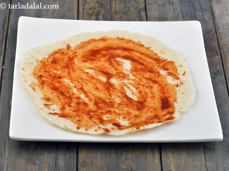 Step 31 – Spread 1 tsp of <a href="https://www.tarladalal.com/red-chilli-garlic-chutney-32641r">red chilli-garlic chutney</a> evenly over it.&nbsp;