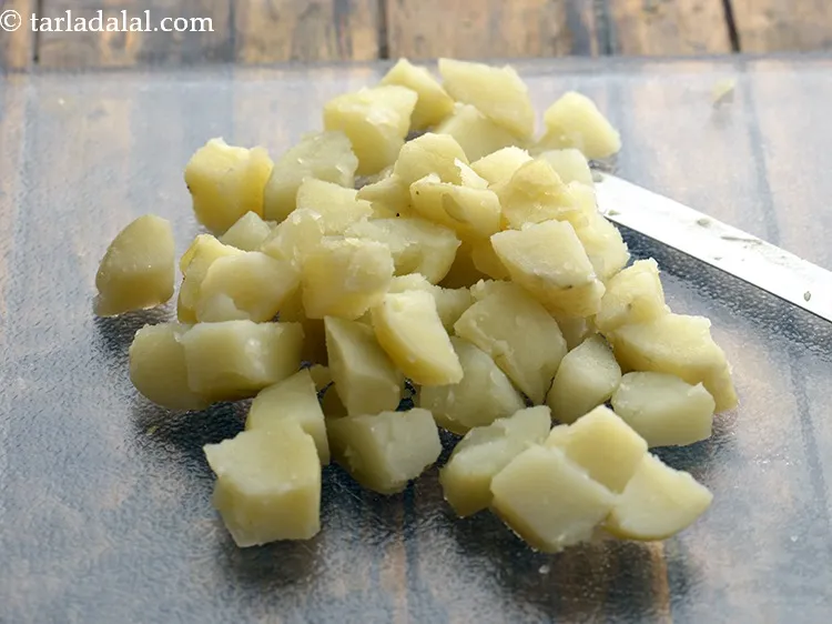 Step 11 – Place them on a chopping board and cut into cubes. Keep aside.