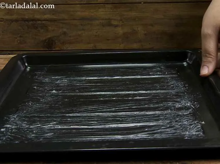 Step 8 – Grease the baking tray with a little butter.