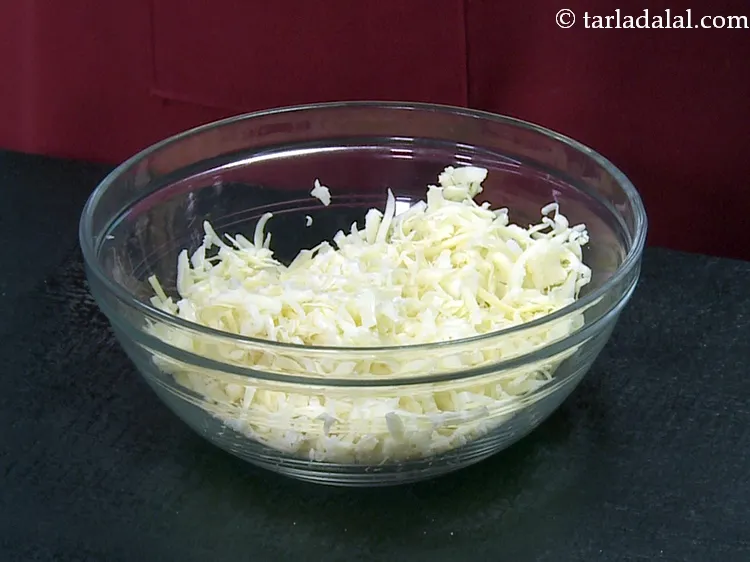 Step 26 – To make the stuffing for<strong> cheese and spring onion samosa</strong>, add 1 3/4 cups&nbsp;<a href="https://www.tarladalal.com/glossary-grated-processed-cheese-868i">grated …