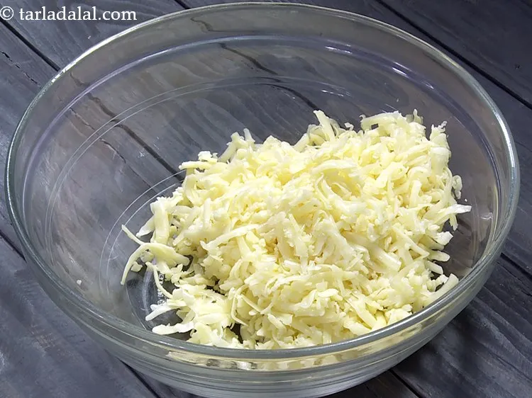 Step 1 – To prepare the mixture for <strong>cheese balls</strong>, in a deep bowl take grated processed cheese. …