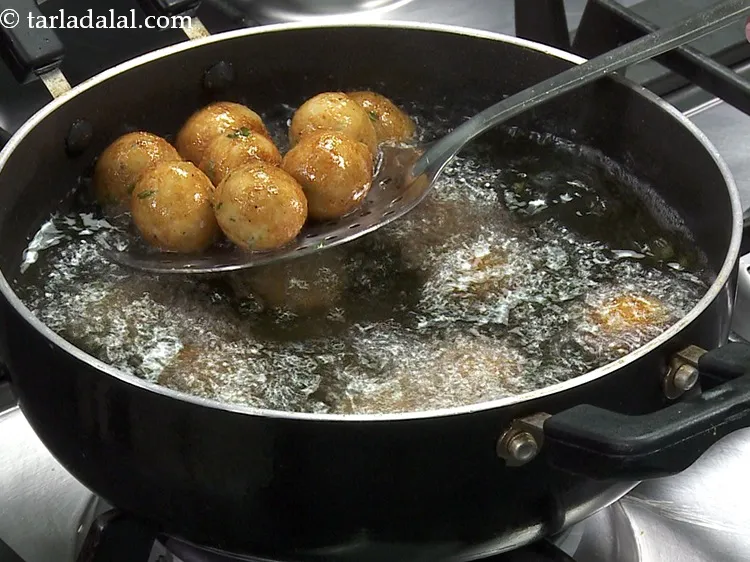 Step 11 – Deep-fry bread cheese balls on a medium flame till they turn golden brown in colour …