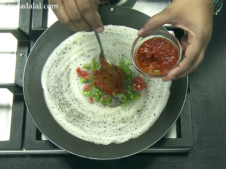 Step 58 – Be a little quick while adding the ingredients on the half cooked dosa.