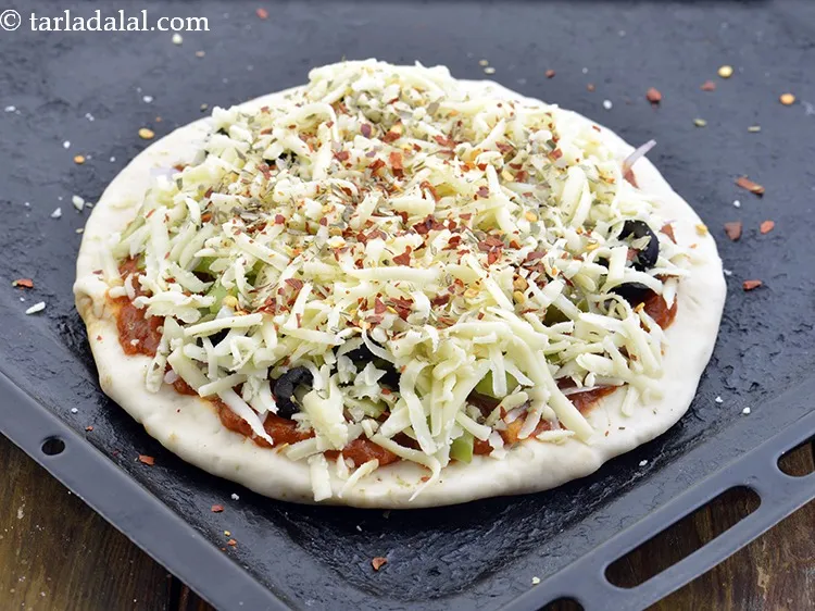 Step 35 – Spread &frac12; tsp <a href="https://www.tarladalal.com/glossary-dry-red-chilli-flakes-paprika-338i">dry red chilli flakes (paprika)</a>&nbsp;evenly over it.