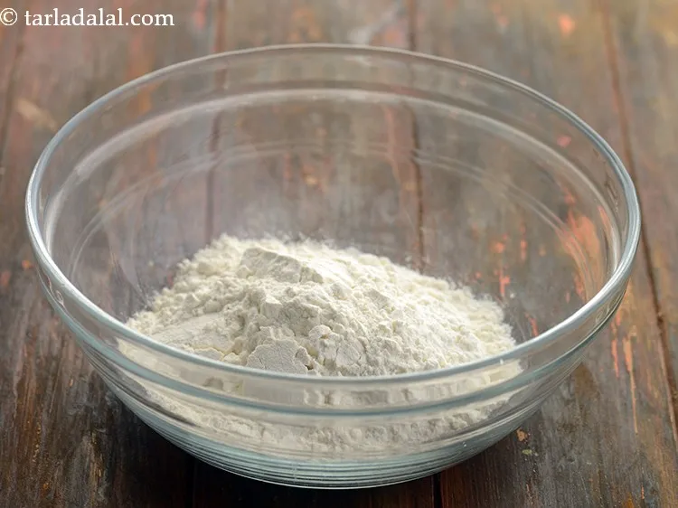 Step 8 – For the dough of <strong>cheese burst pizza</strong>, add 1 cup&nbsp;<a href="https://www.tarladalal.com/glossary-plain-flour-maida-188i">plain flour (maida)</a>&nbsp;in a deep …