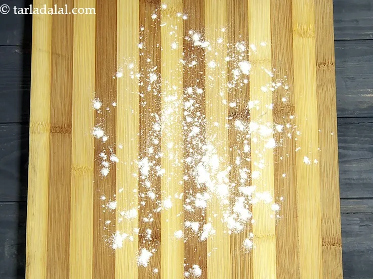 Step 19 – Take a rolling board and dust some plain flour on it.