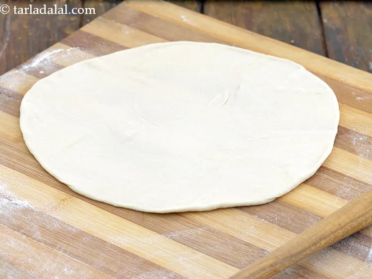 Step 21 – Roll a portion of the dough into a 175 mm. (7&rdquo;) diameter circle using a …