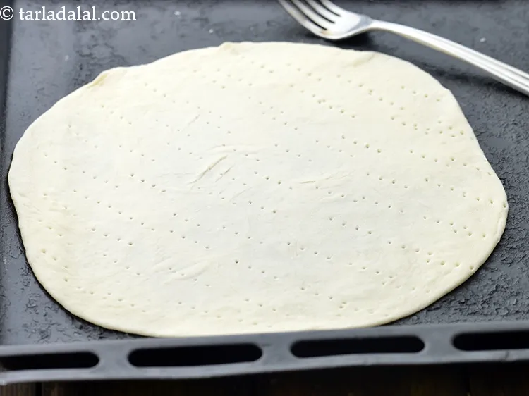 Step 24 – Roll another portion of the dough into a 200 mm. (8&rdquo;) diameter circle using a …