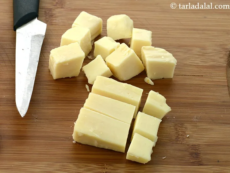 Step 10 – Add 5 tbsp&nbsp;<a href="https://www.tarladalal.com/glossary-cheese-cubes-307i">cheese cubes</a>.