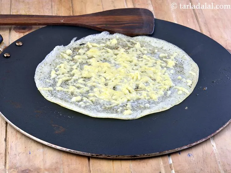 Step 11 – Cook <strong>crispy cheese dosa</strong> on a medium flame for 1 minute or till the cheese …