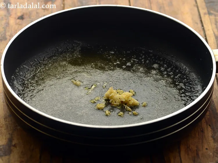 Step 3 – Add the garlic which will perk up the flavour of our <strong>cheese fondue</strong>.&nbsp;