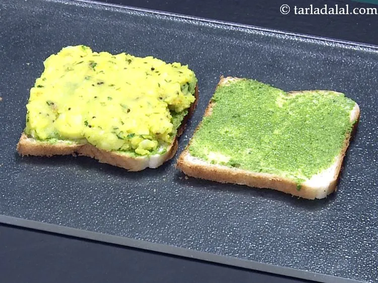 Step 21 – Place a portion of the stuffing on a buttered-chutney bread slice and spread it evenly.&nbsp;